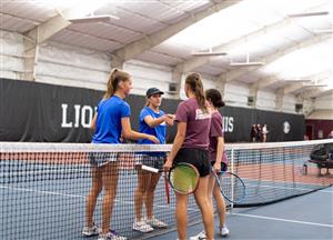A group of women holding tennis racketsDescription automatically generated with medium confidence